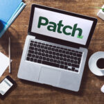 Patch newsroom editors access Dataminr on laptop to monitor real-time breaking news alerts across multiple communities