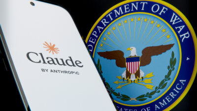 Anthropic's Claude app icon next to the Department of War seal, symbolizing the company's ongoing dispute with the Pentagon